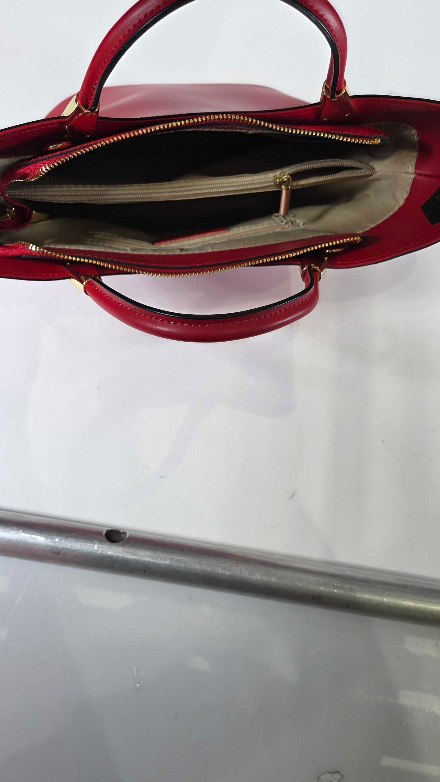 Red handbag with a visible brand logo on a white background
