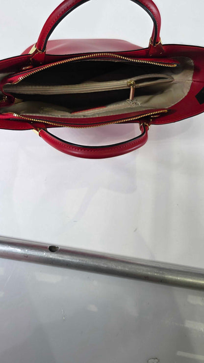 Red handbag with a visible brand logo on a white background