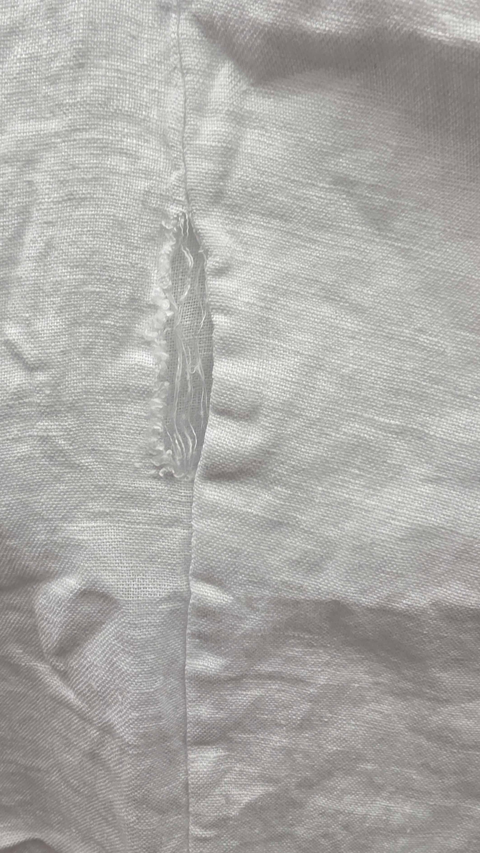 Close-up of gray fabric with a visible seam and texture