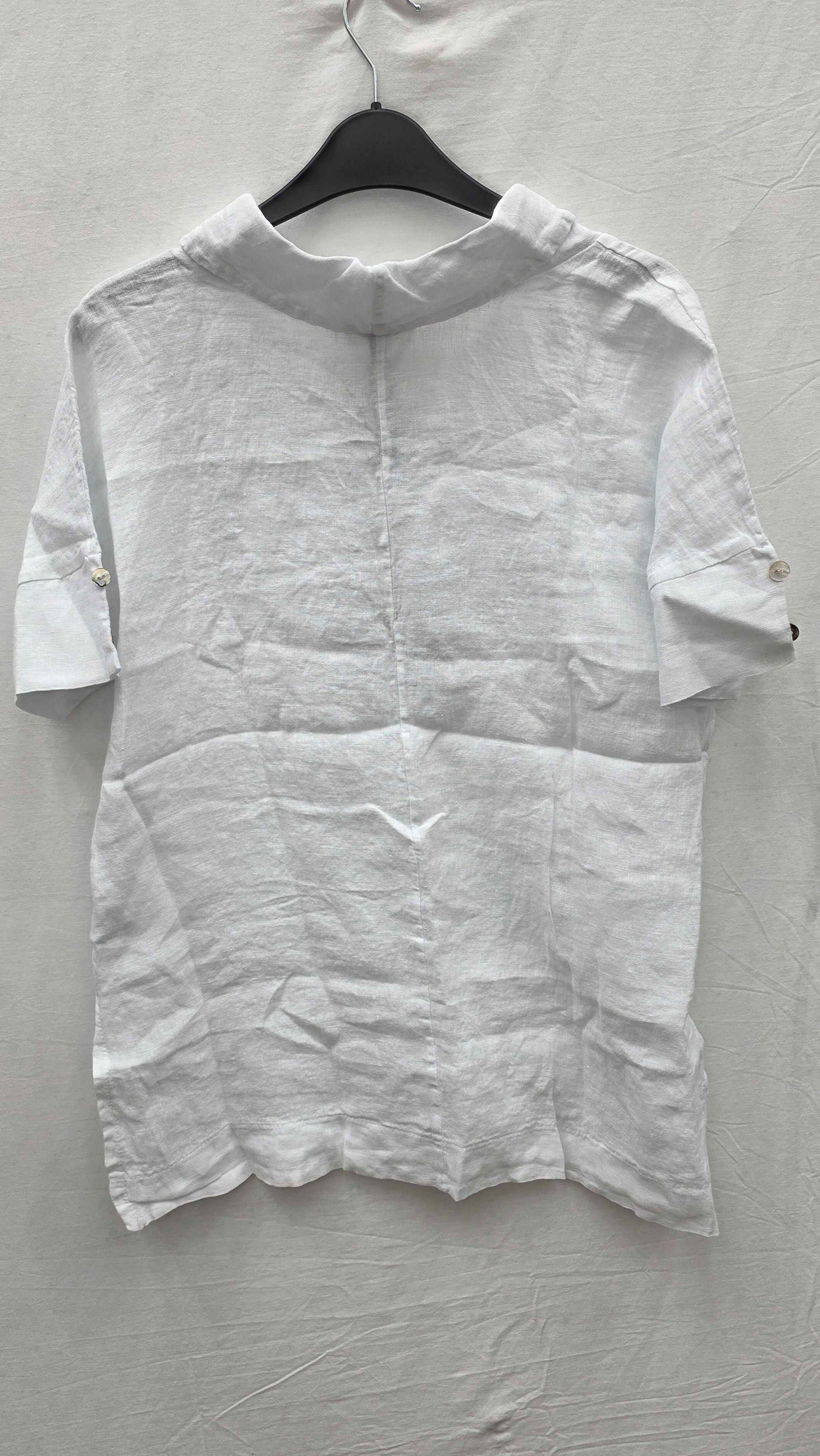 White shirt on a hanger against a gray background