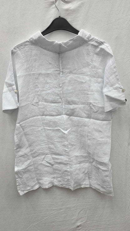 White shirt on a hanger against a gray background